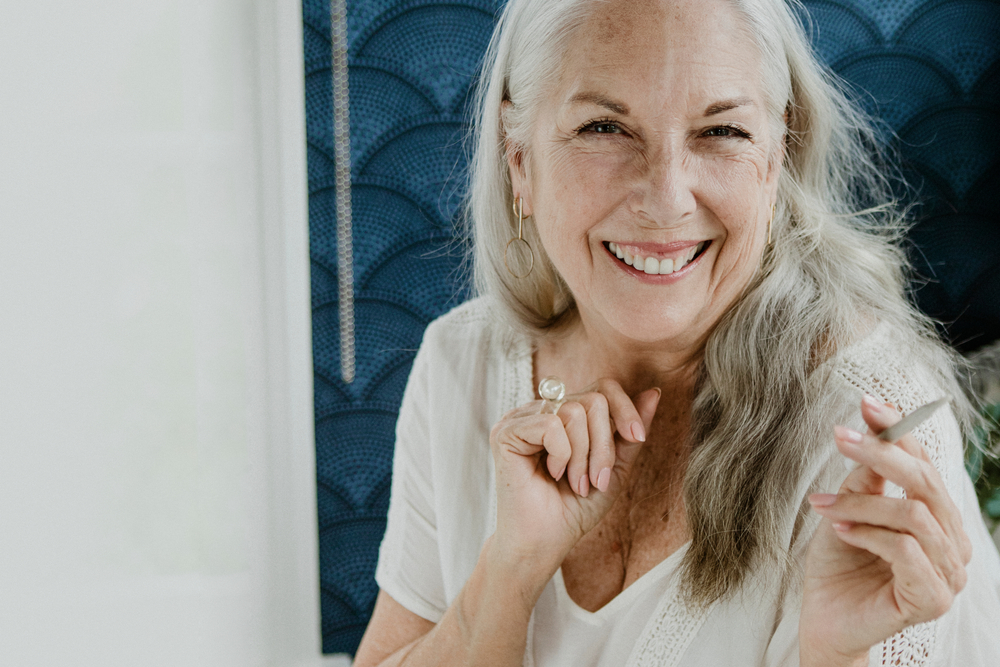 Senior woman holding a joint in her hand