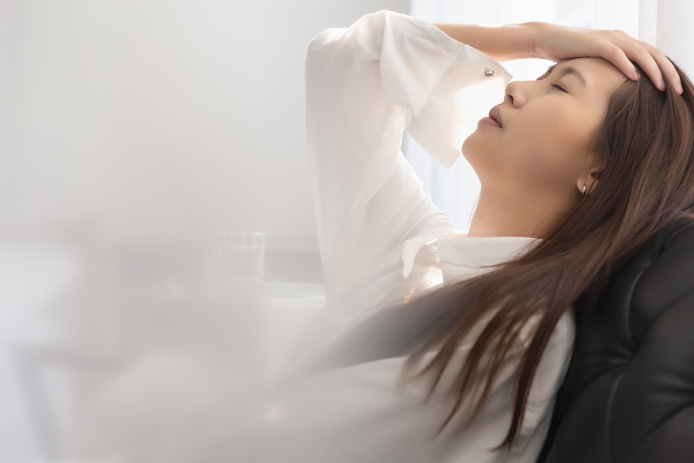 Asian woman feeling sick have a headache, coughing because of Coronavirus Covid-19. Protection and recovery from the illness quarantine at home, Stay at home.