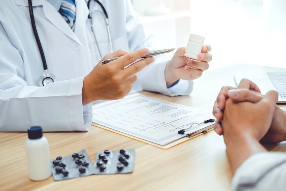 Doctor or physician recommend pills medical prescription to male Patient