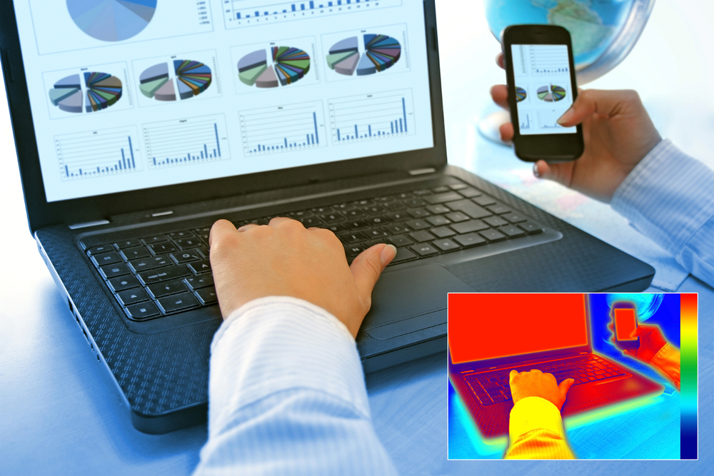 Infrared thermography image showing the heat and radiation of Notebook and smartphones in the office
