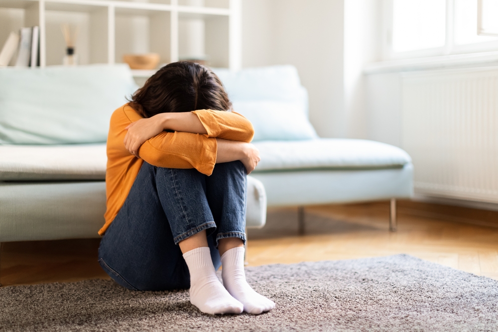 Depression Concept. Portrait Of Upset Young Middle Eastern Woman Crying At Home, Depressed Millennial Lady Burying Head In Knees While Sitting On Floor In Room, Suffering Mental Breakdown, Copy Space