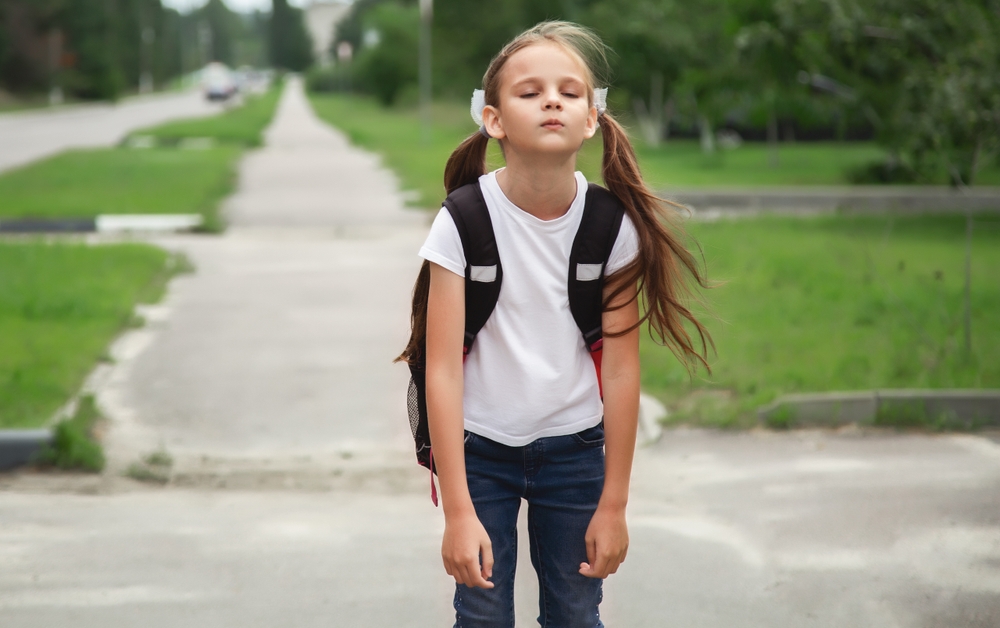 first day of school. student girl primary school is upset and does not want to go to class. The first day of autumn. concept back to school.
