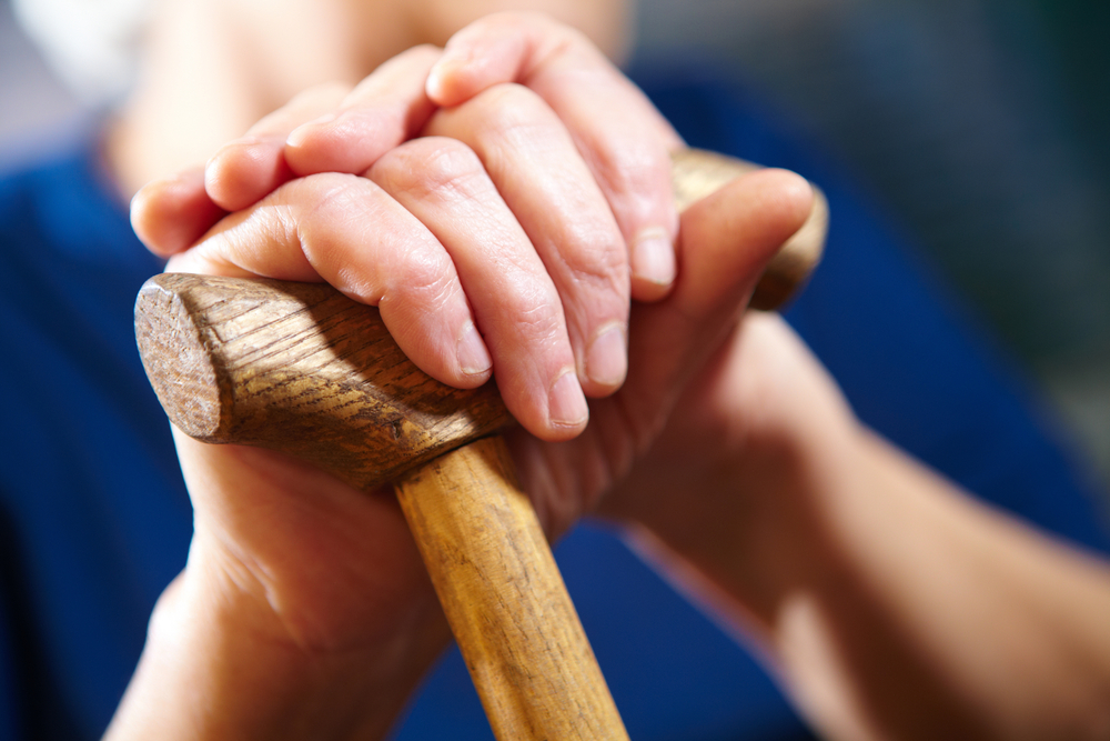 Old woman hands with cane. Senior people health care.