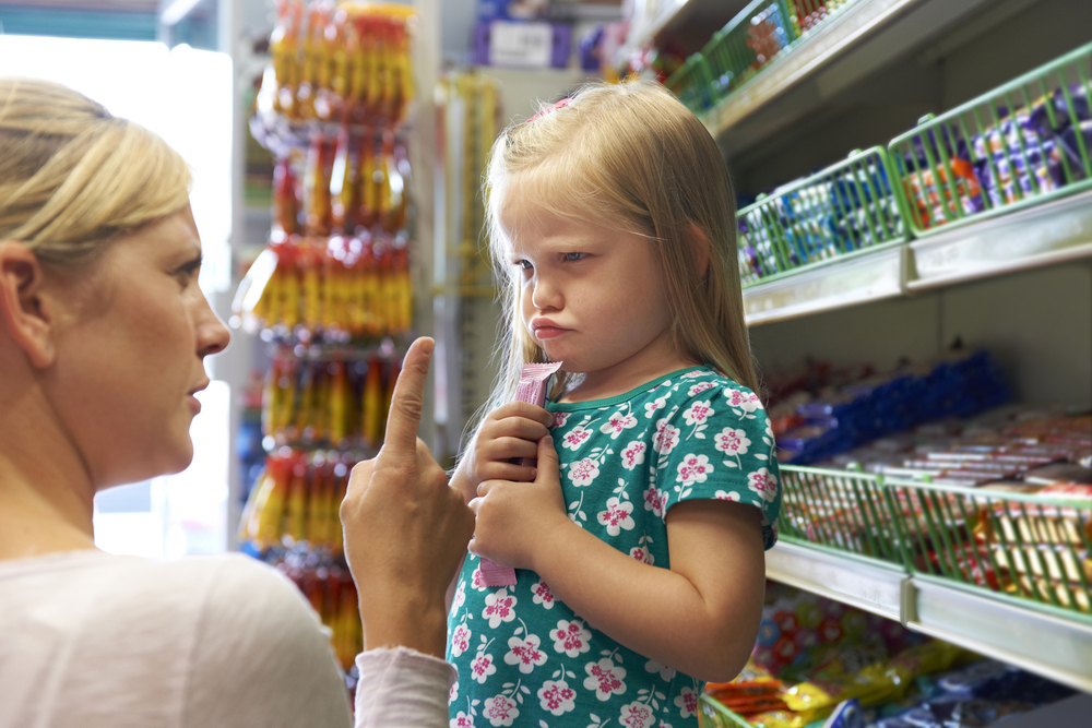 Child Having Argument With Mother At Candy Counter
