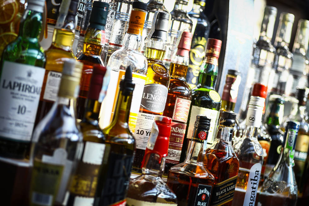 Bucharest, Romania - September 9, 2015: Several types of bottled alcohol are displayed on some shelves in a pub in Bucharest, Romania.