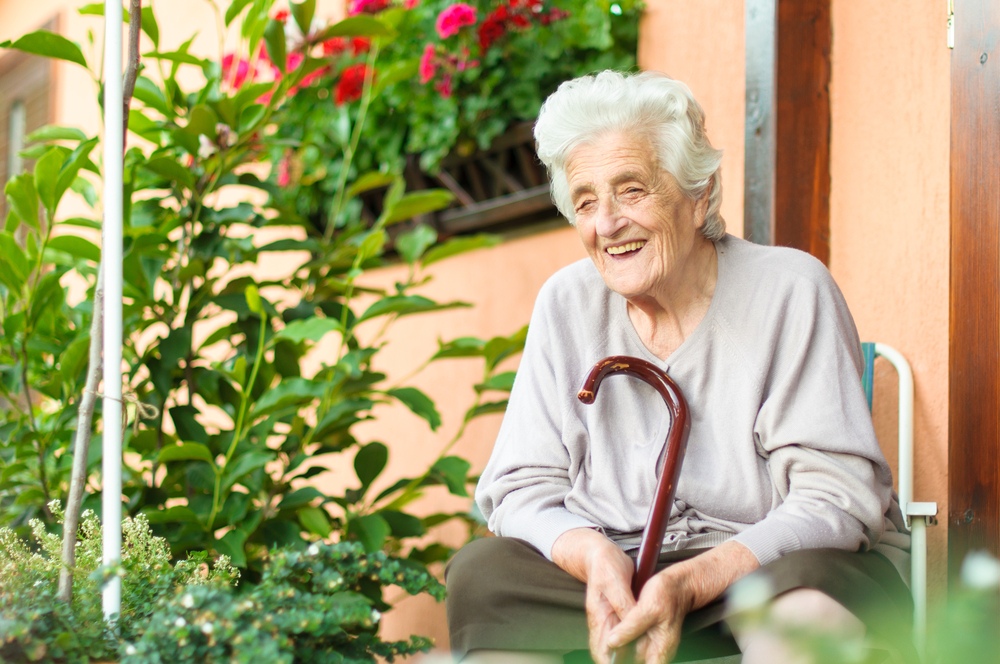 Happy senior woman sitting outside
