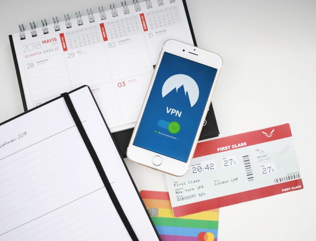 Airline ticket, credit card, and calendars against a white background. 