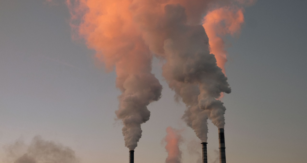 Factories releasing smog. Sky in the background.