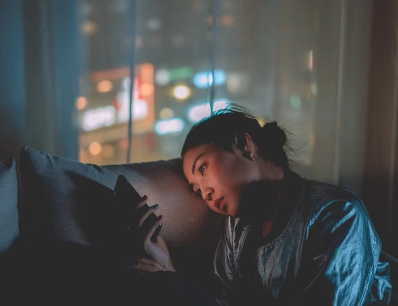 Woman using phone at night