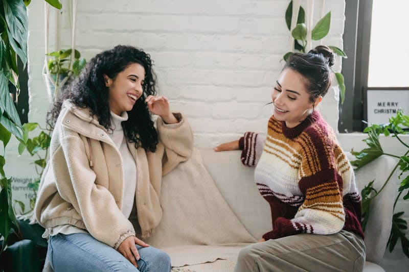 Two women chatting on the sofa