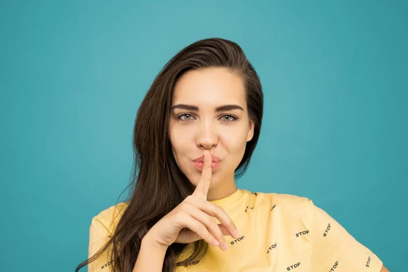Woman making a shushing gesture