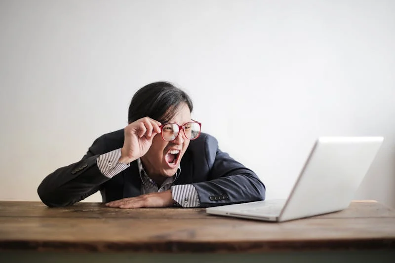 Man shocked looking at computer