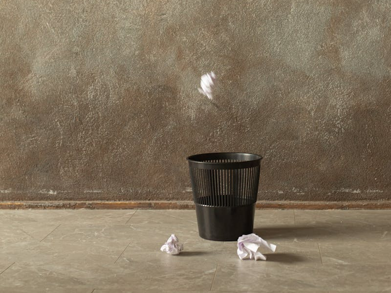 papers thrown at a trash bin
