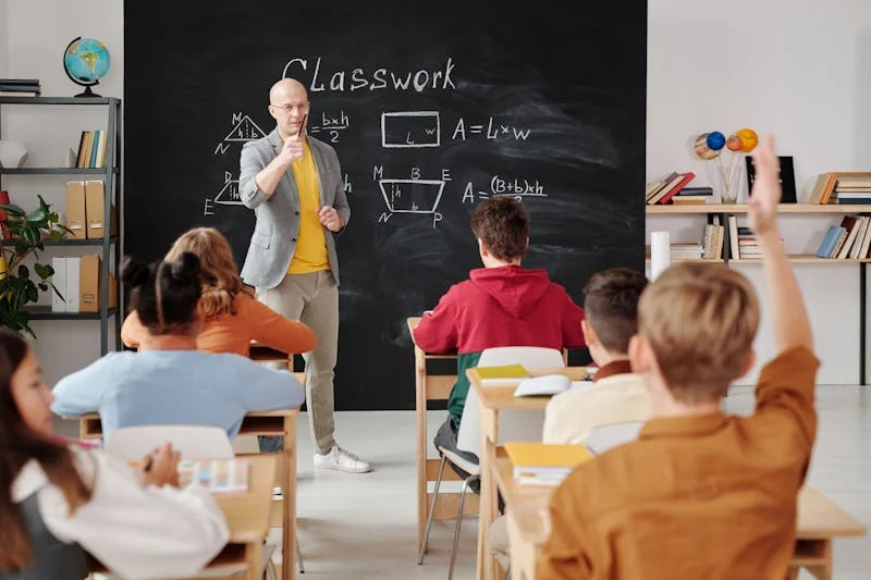 kid in class with hand raised