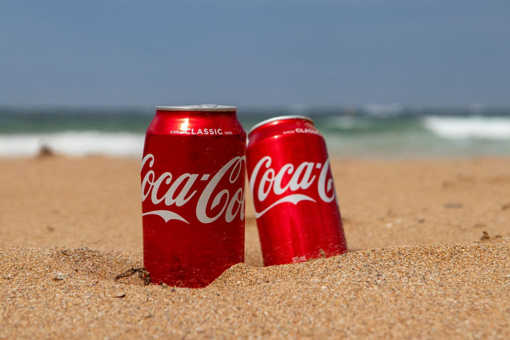 Coke cans in the sand
