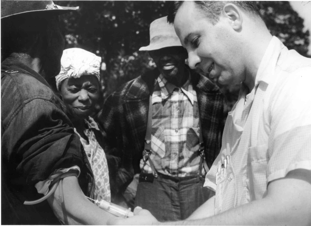 drawing blood from a patient as part of the Tuskegee syphilis experiments. 