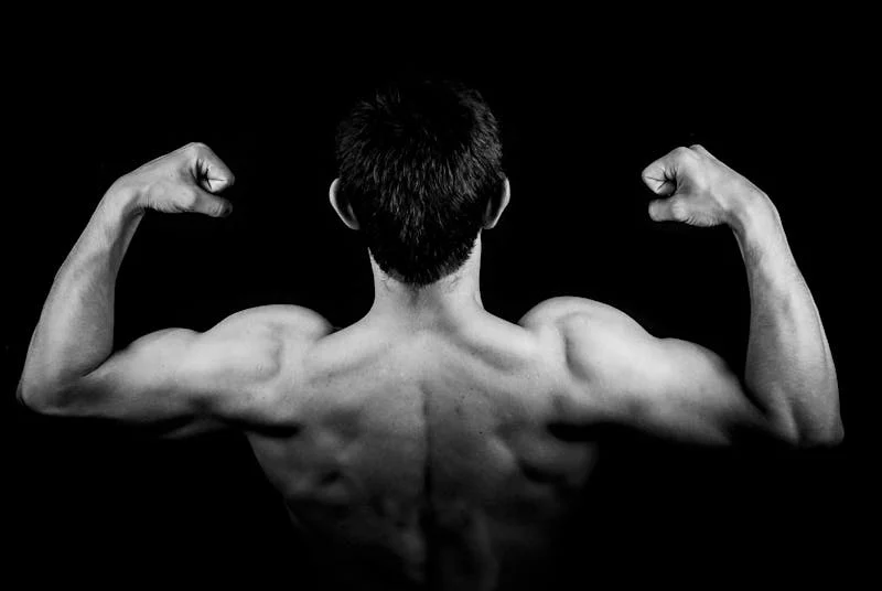 muscles flexed from behind