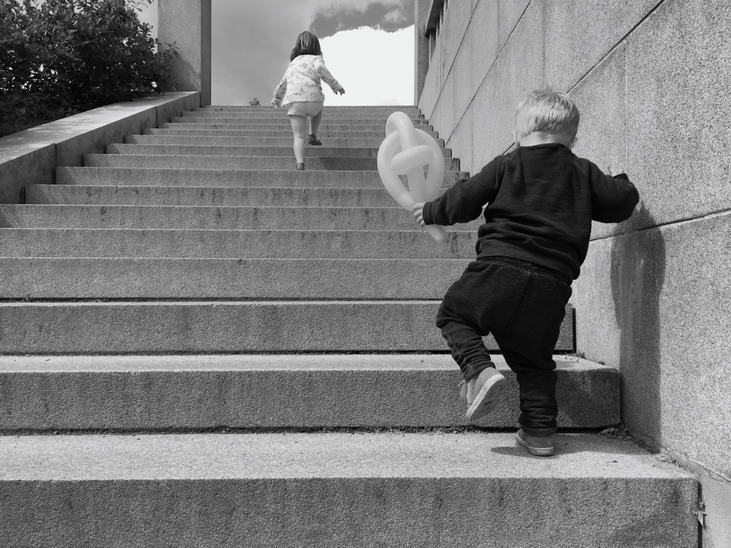 girl ahead of boy on stairs