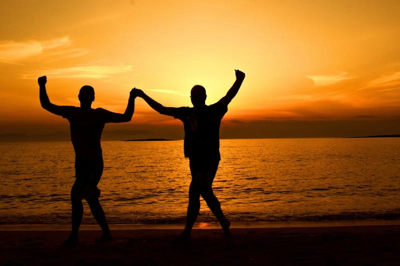 Two people running on a beach