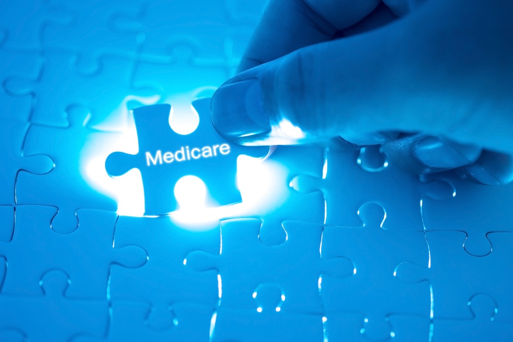 Health Care Concept. Doctor holding a jigsaw puzzle with medicare word.