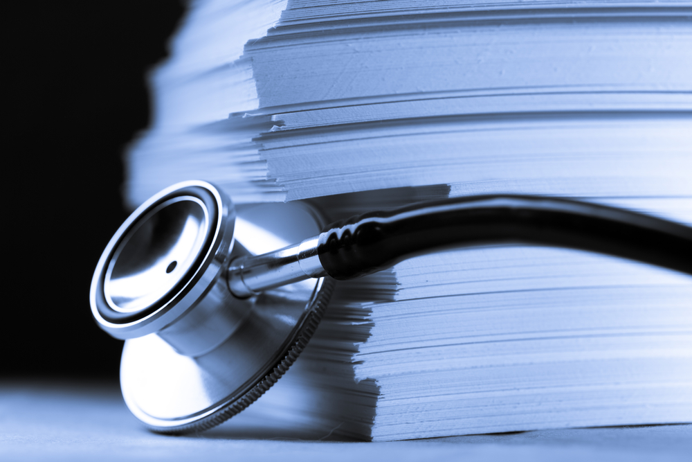 Stethoscope and heap of paper cards