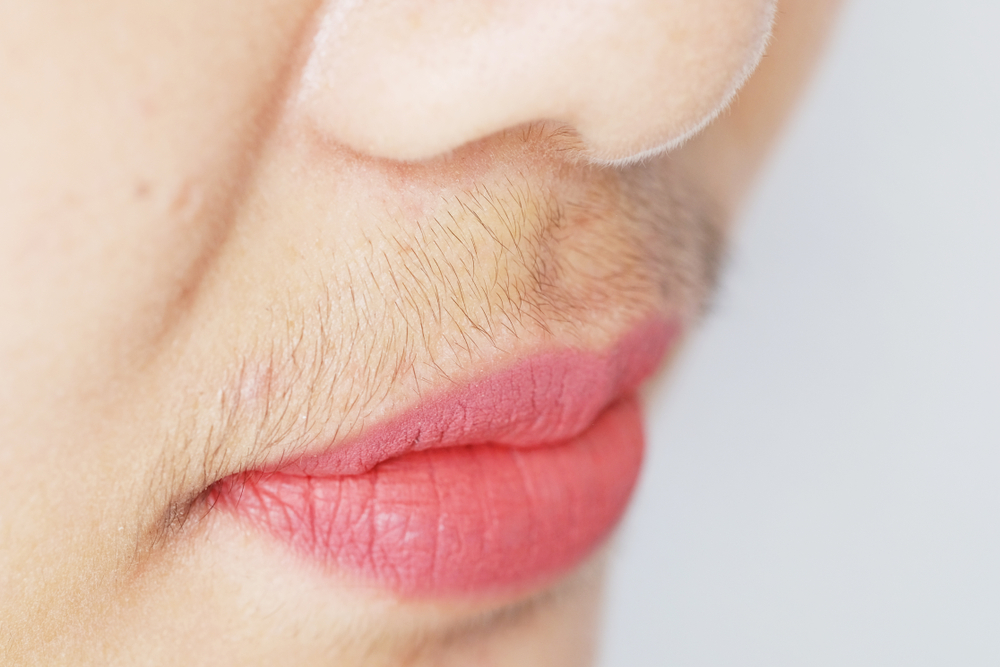 Asian woman mustache.Closeup.
