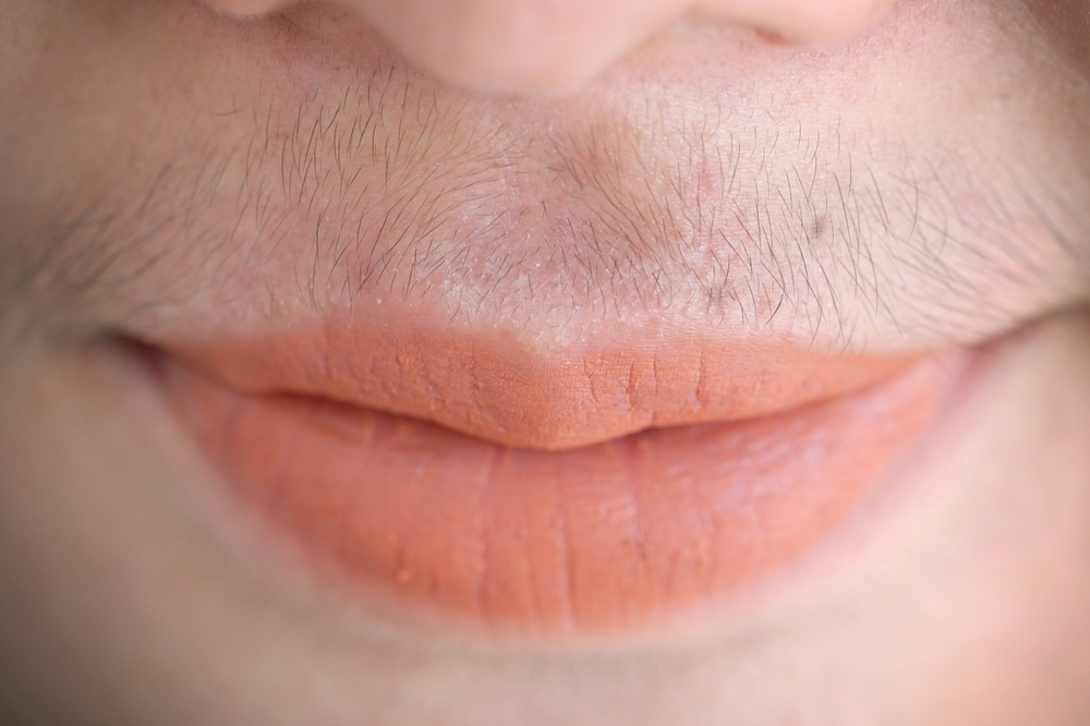 Asian woman mustache.Closeup.