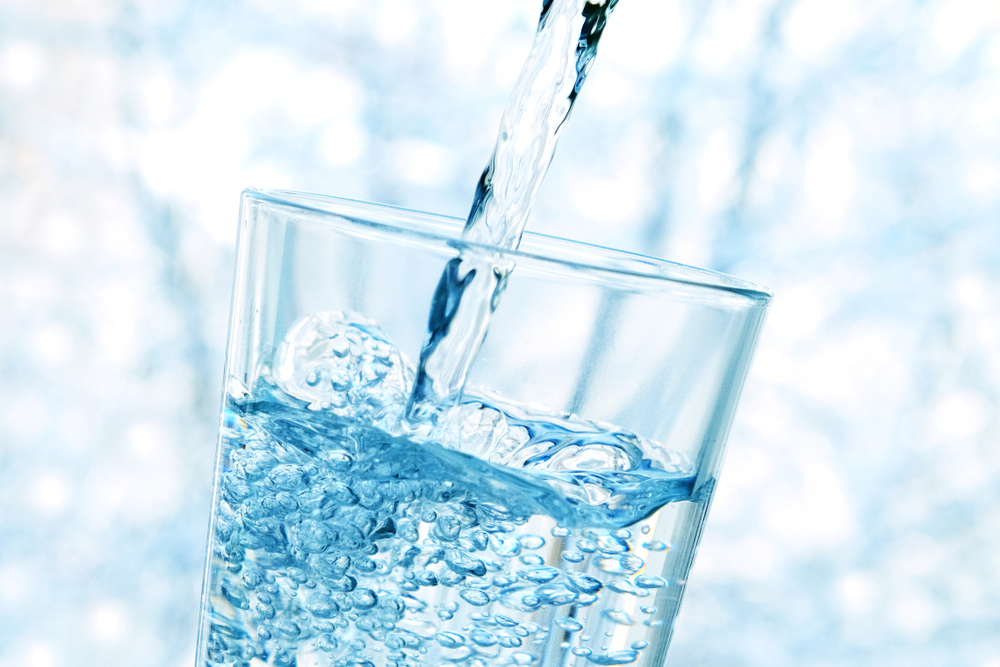 glass of water. glass cup of mineral water with bubbles on a winter blue background in the mountains. healthy lifestyle. sport. pure water. healthy food. melt water of mountain peaks and ice. spring