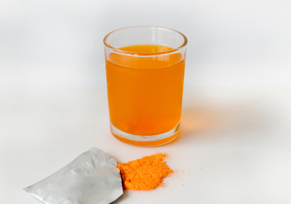 Electrolyte drink in a glass of white background