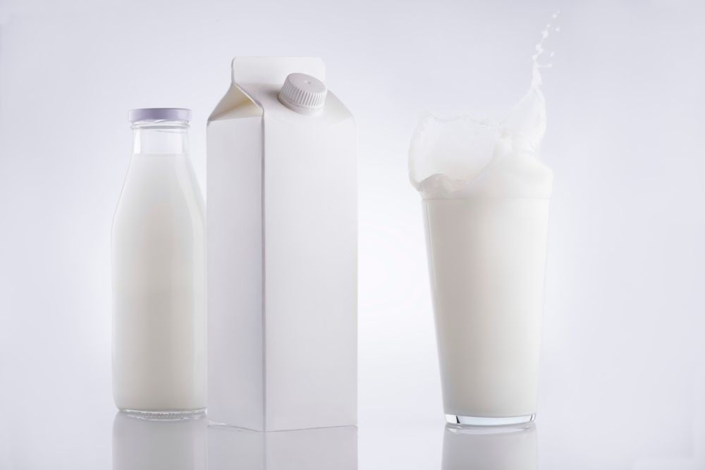 White on white milk bottle, milk carton and milk glass with splash.