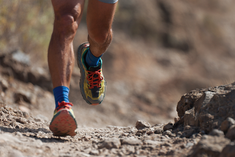 Trail running action close up of running shoes in action