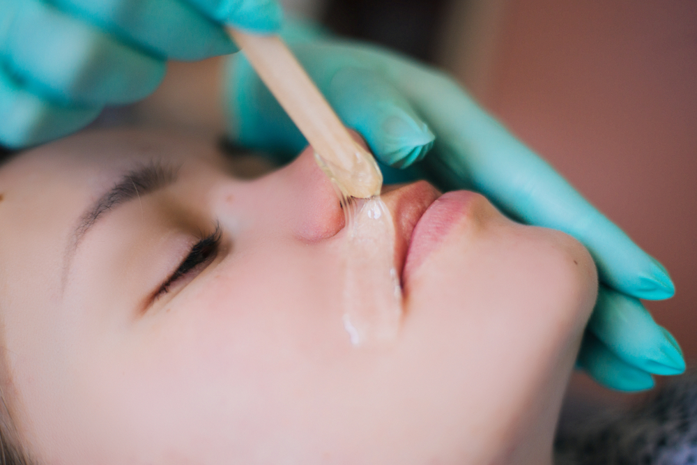 Depilation of facial hair. Remove whiskers under the nose with sugar.