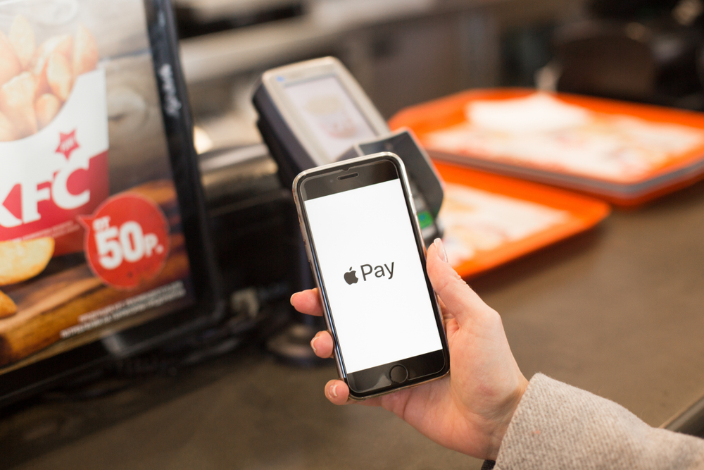 Nizhny Novgorod, Russia - March 28, 2019: Close-up view of girl using Apple Pay on a iphone paying for purchases 
