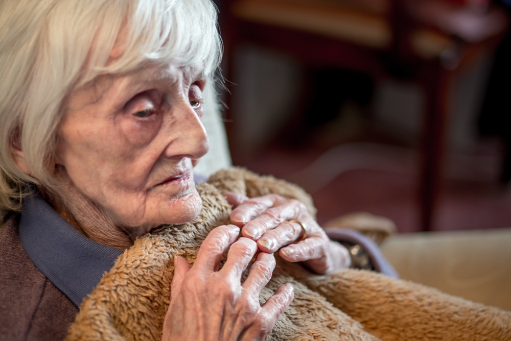 The ninety year old lady is covered in an insulating blanket to try and stay warm as she is very sensative to the cold weather and heating costs are expensive at this time of year.
