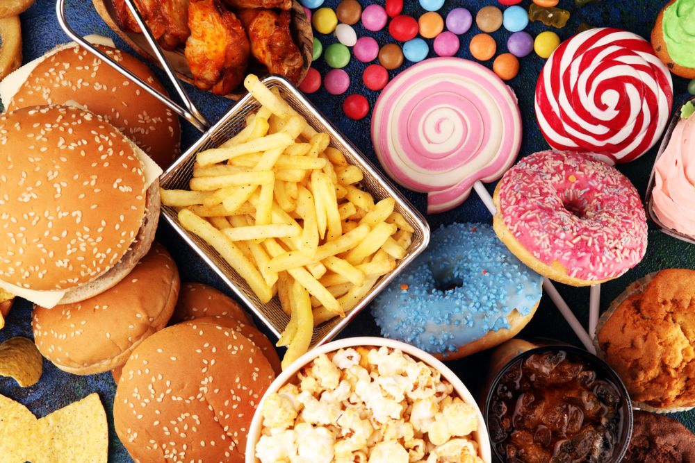 Unhealthy products. food bad for figure, skin, heart and teeth. Assortment of fast carbohydrates food with fries and cola