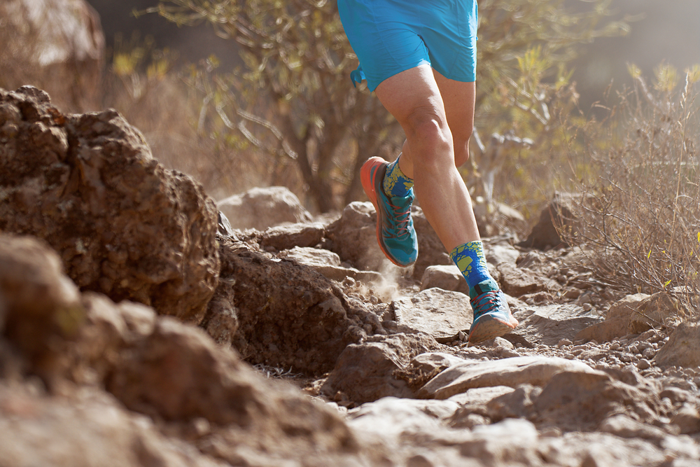 Trail running action close up of running shoes in action