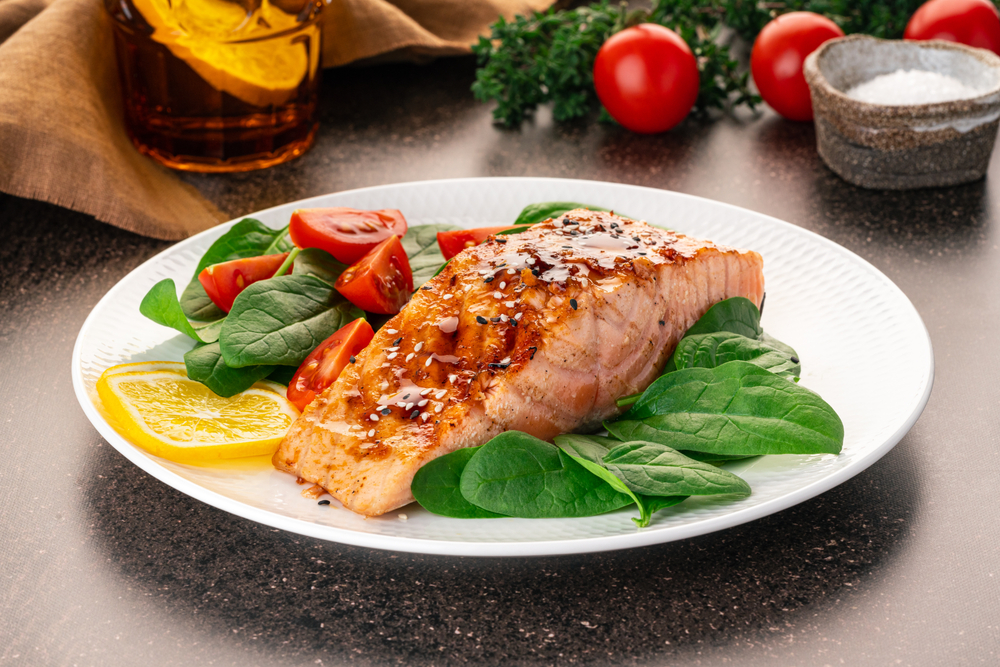 Baked or fried salmon and salad, Paleo, keto, fodmap, dash diet. Mediterranean food with steamed fish. Oven asian dish with teriyaki. Healthy concept, gluten free, lectine free, side view
