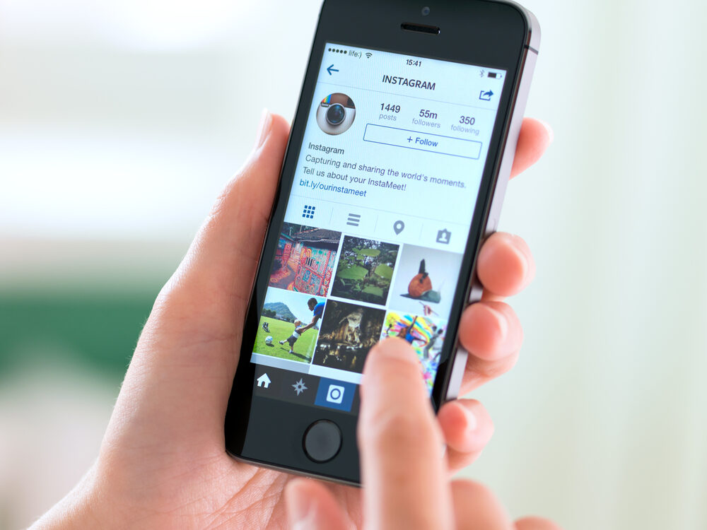 KIEV, UKRAINE - MAY 30, 2014: Person holding a brand new Apple iPhone 5S with Instagram profile on the screen. Instagram is an online mobile social networking service, launched in October 2010.