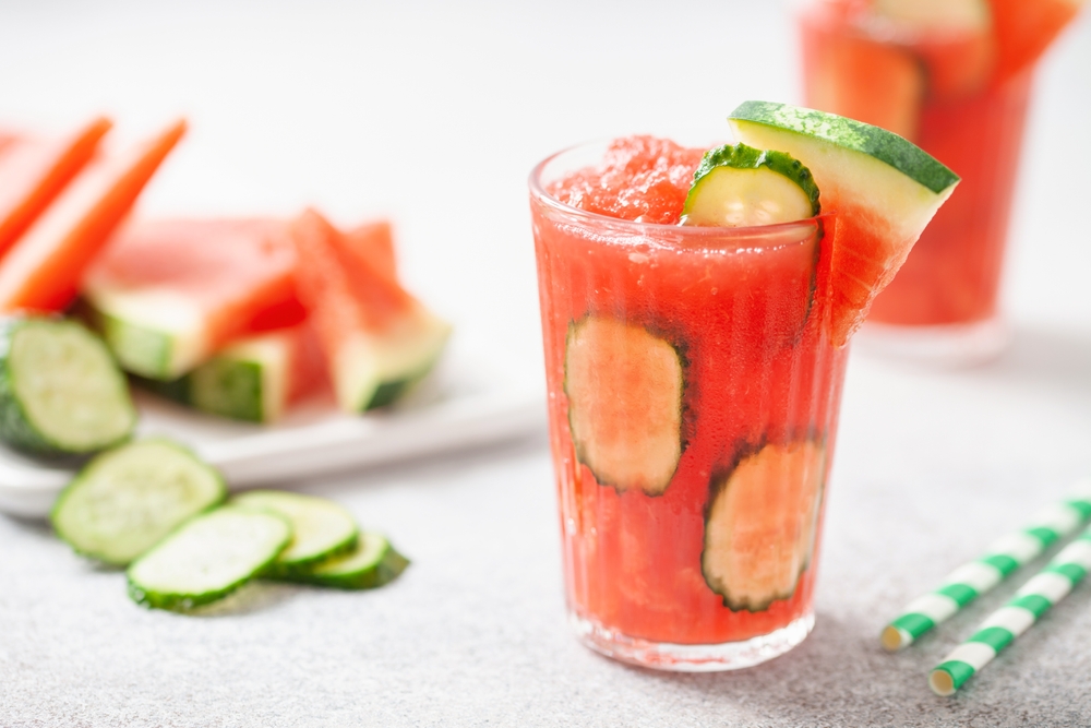 Refreshing cold summer drink watermelon slushie with cucumber slices in glass