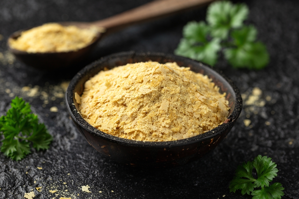 Dried nutritional yeast flakes, vegan vegetarian seasoning healthy food supplement