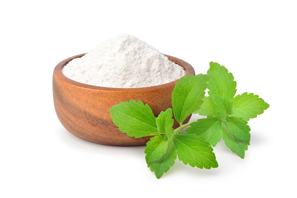 Stevia sugar with fresh stevia leaves isolated on white background.
