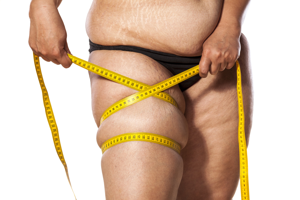 woman measure her leg with tape
