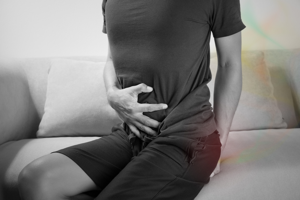 A man sitting farting on sofa