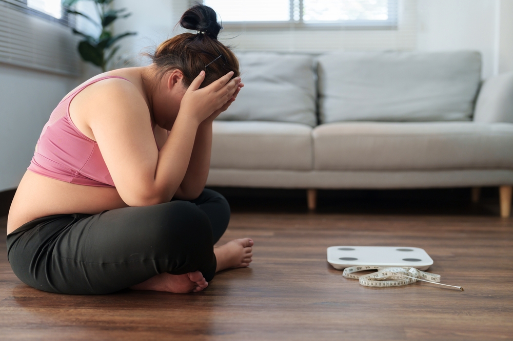 Stressful Asian overweight woman sad of dieting Weight loss fail.