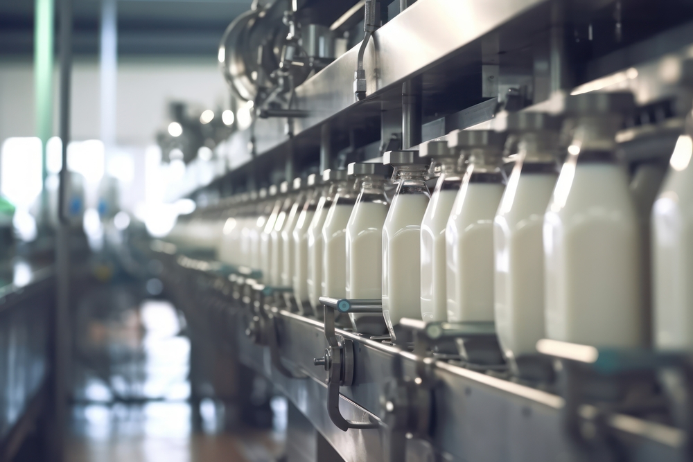 Milk factory. Robotic factory line for processing and bottling of milk. Selective focus.