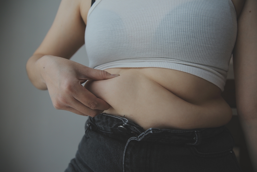 fat woman, fat belly, chubby, obese woman hand holding excessive belly fat with measure tape, woman diet lifestyle concept