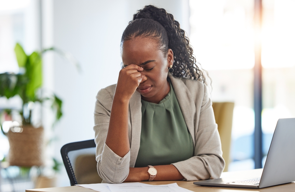 Crisis, stress and black woman with problem in office, sick or headache from brain fog. Frustrated, fatigue and African professional with business fail, mistake emoji or debt, bankruptcy or tax audit