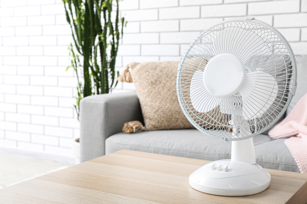 Modern electric fan on table in living room