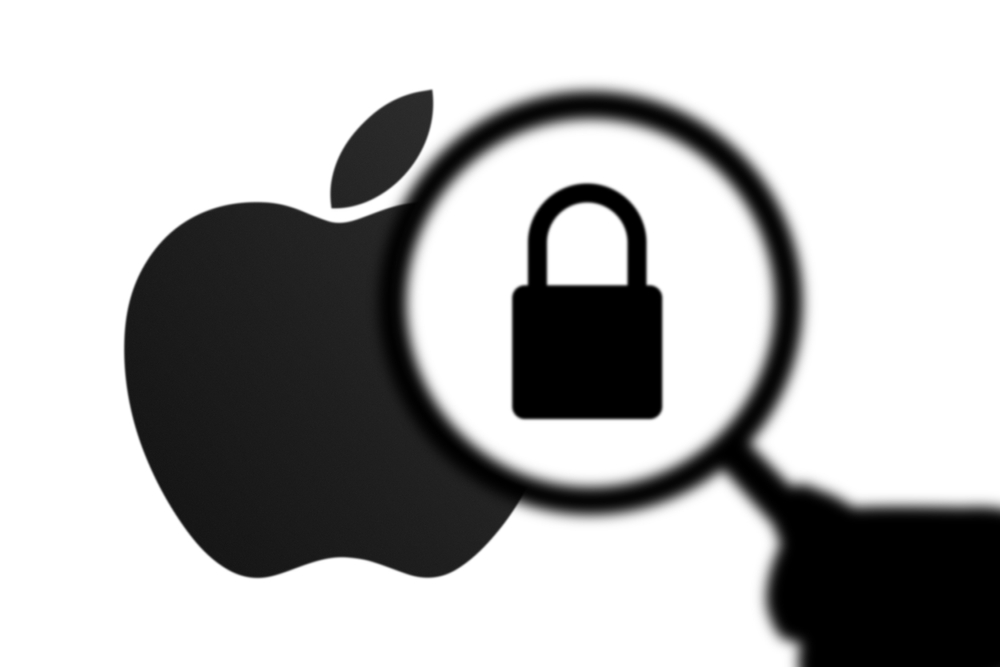 California, United States - Sept 21 2023: Apple Security, Privacy Issues - Lock, Unlock. Silhouette of a hand holding a Magnifying glass in front of the Apple Logo