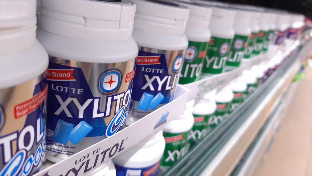 Chewing gum brand Xylitol. Displayed on shelf in supermarket to buy sell. Various flavors fresh mint bubblegum. Colorful pack. Selective focus, blurred aisle background. Java, Indonesia - Feb 5, 2023